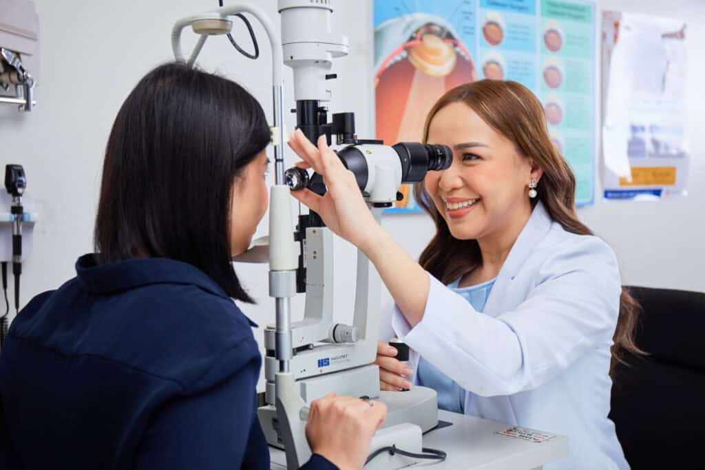 Asian Eye doctor examining patient for AMD