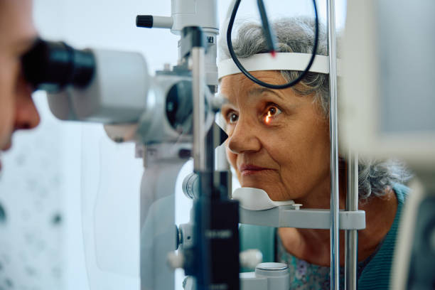 Elderly woman having her eyesight low vision checked at ophthalmology clinic.