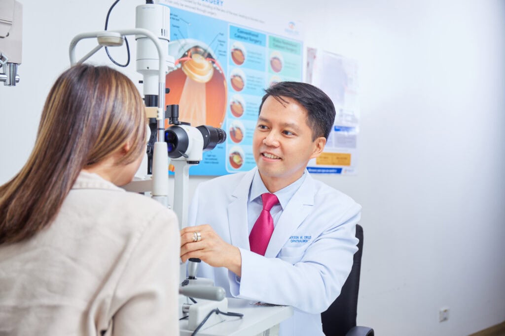 Asian Eye Doctor Emerson Cruz checking on patient