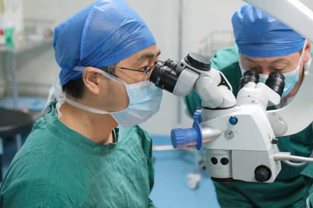 doctors and nurse performing eye surgery
