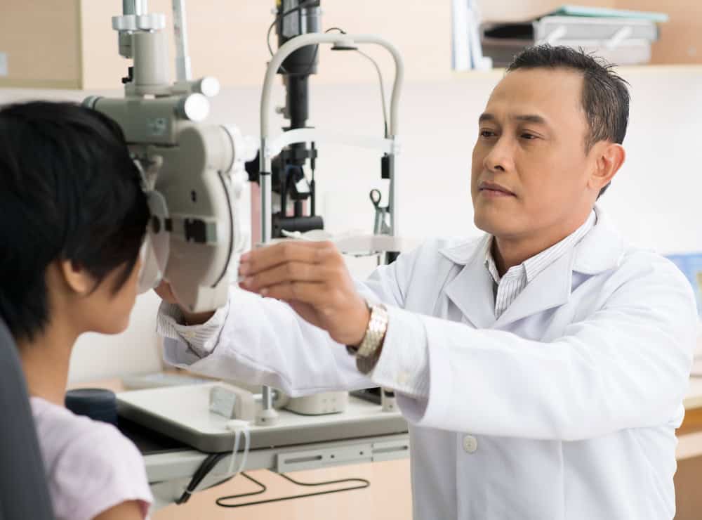 an eye doctor seeing a patient