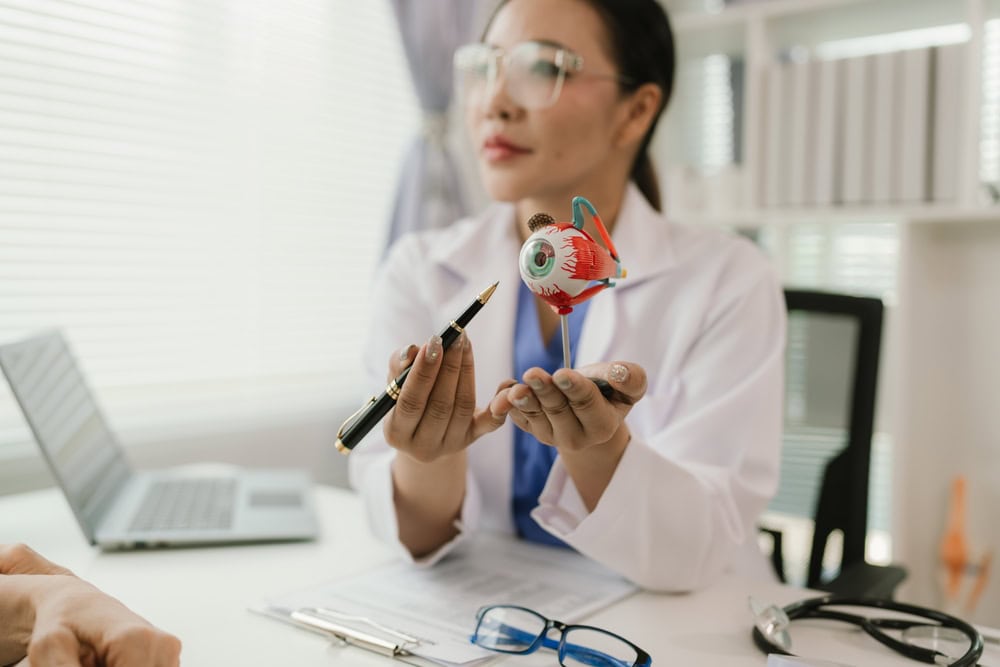 an eye doctor holding an eye figure