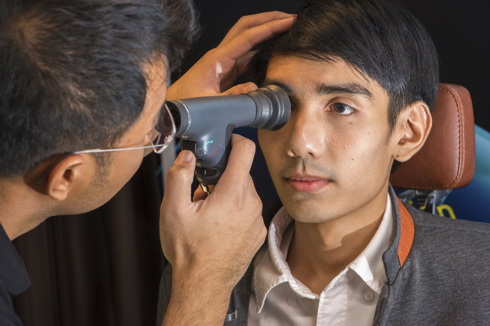 an eye doctor seeing a patient