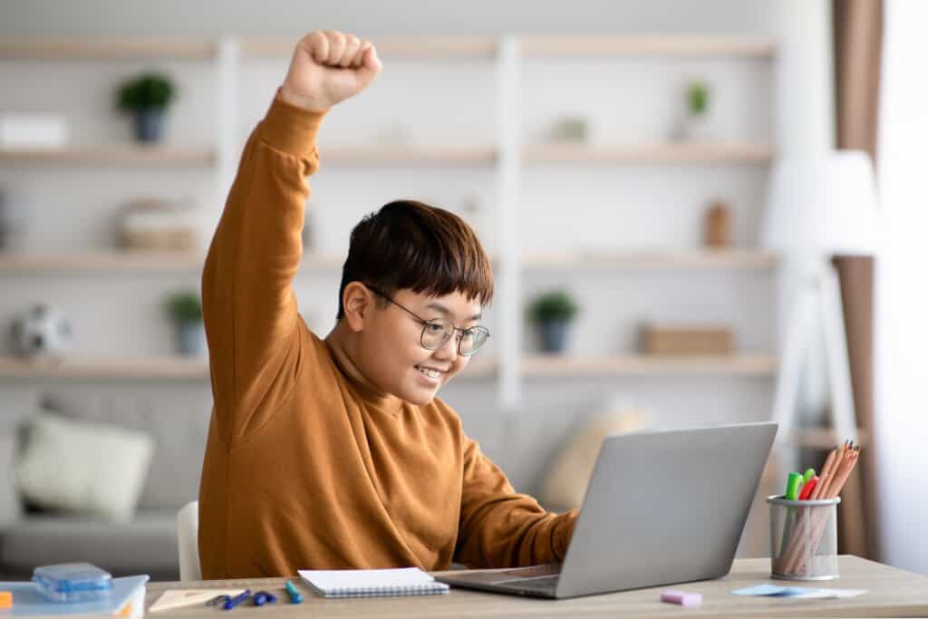 a kid using a laptop